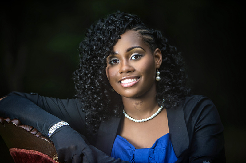 person smiling and posing for a senior portrait