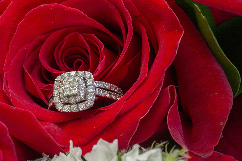 wedding band inside of a red rose