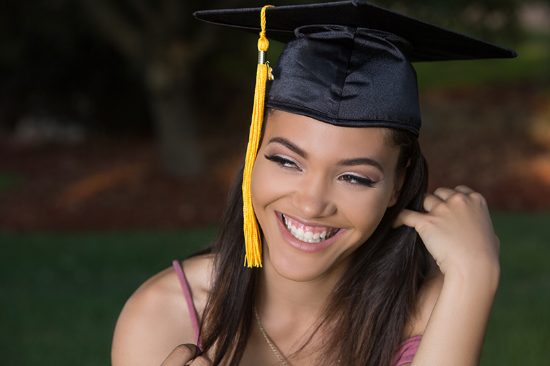 senior smiling with graduation cap